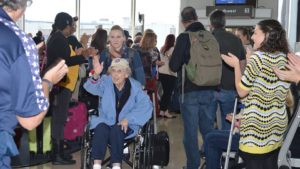 old woman in wheel chair going through airport