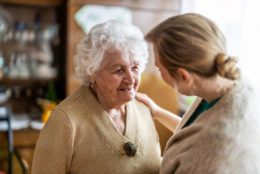 woman discussing with old woman about moving from independent living to assisted living