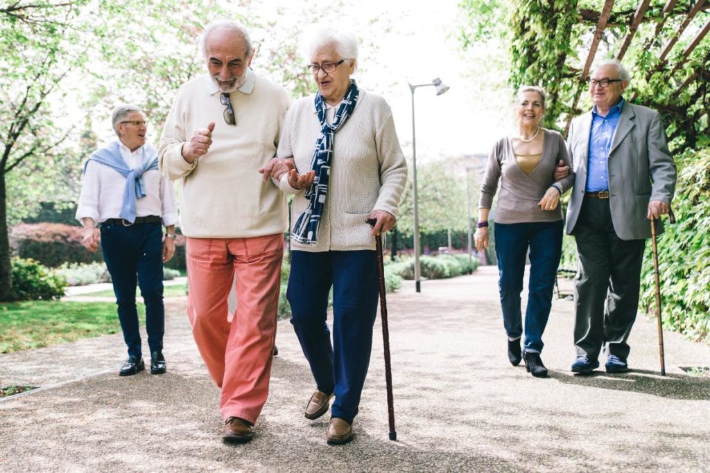 a group of people walk which is one of the healthy habits for seniors