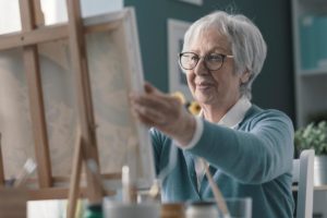 a senior paints one of the many hobbies for seniors