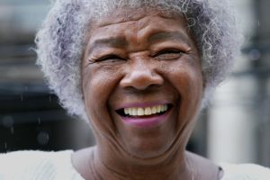 a person smiles at the camera enjoying Respite care for senior