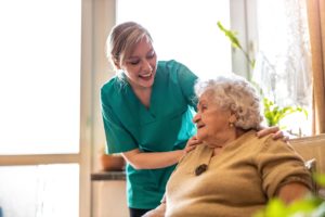 a nurse checks on a senior one of the benefits of assisted living
