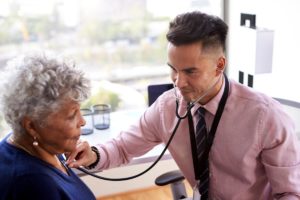 a doctor checks for signs of Pneumonia in seniors