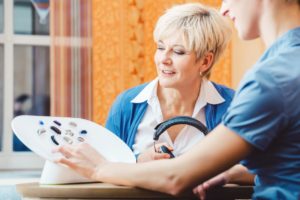a doctor reviews the signs of hearing loss in seniors with a patient