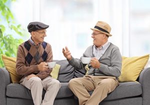 two seniors talk on a couch about Senior Living in Austin, TX