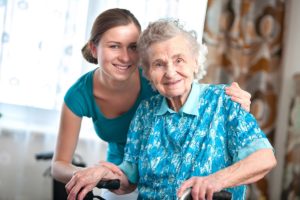 Resident and caregiver smiling in program that provides long-term skilled nursing for seniors