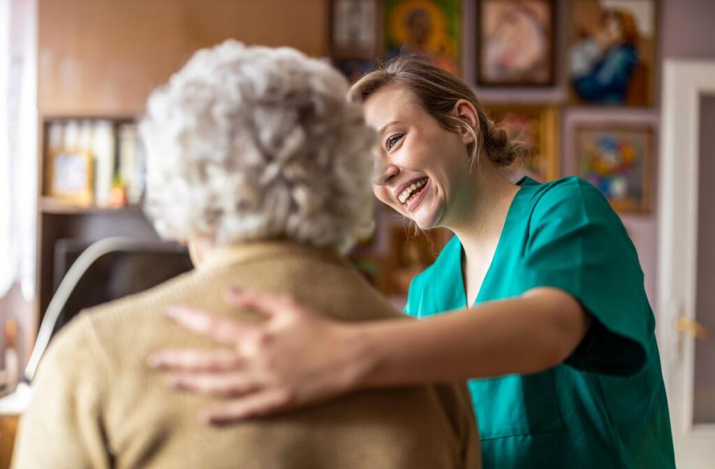 Caretaker discussing respite care examples with elderly woman