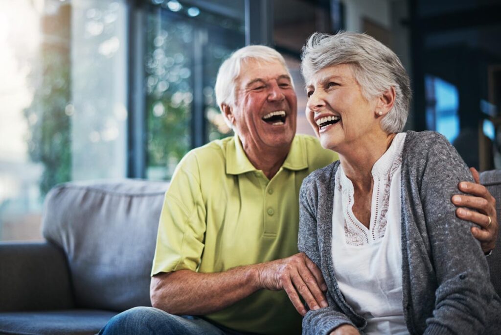 Two older adults laughing while achieving goals of independent living