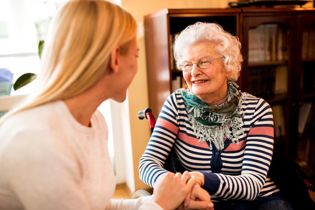 Happy senior woman and a loved one discussing reasons for senior independent living