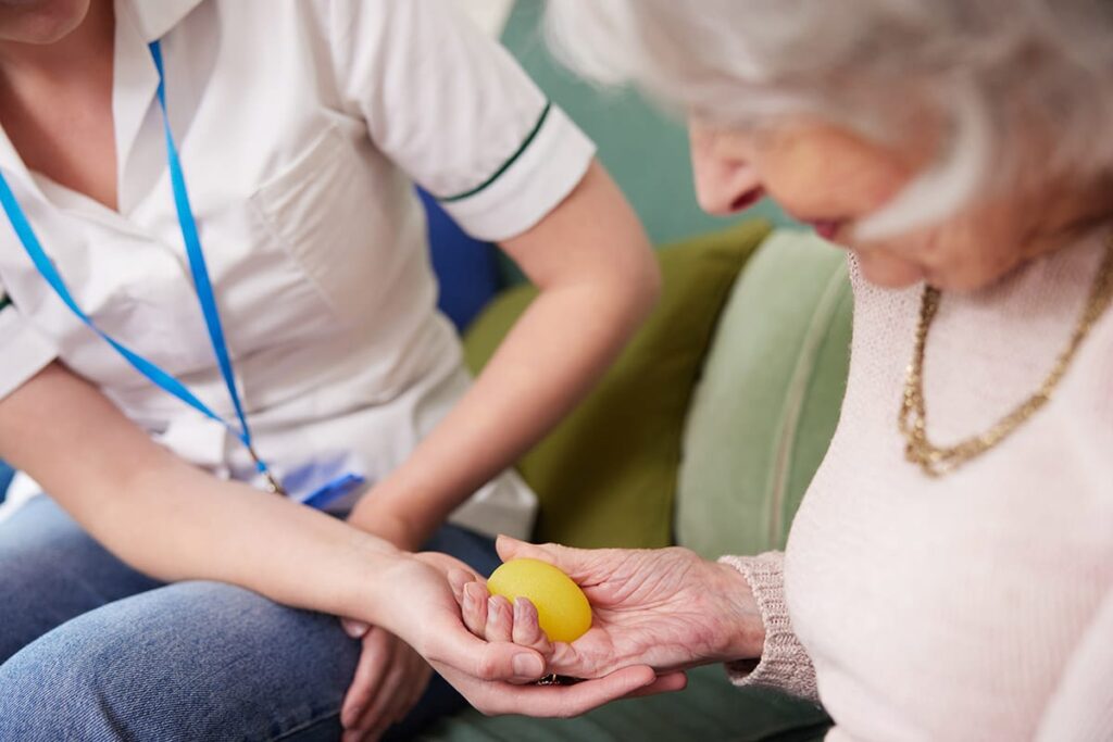 Senior reaping occupational therapy benefits with caregiver in occupational therapy