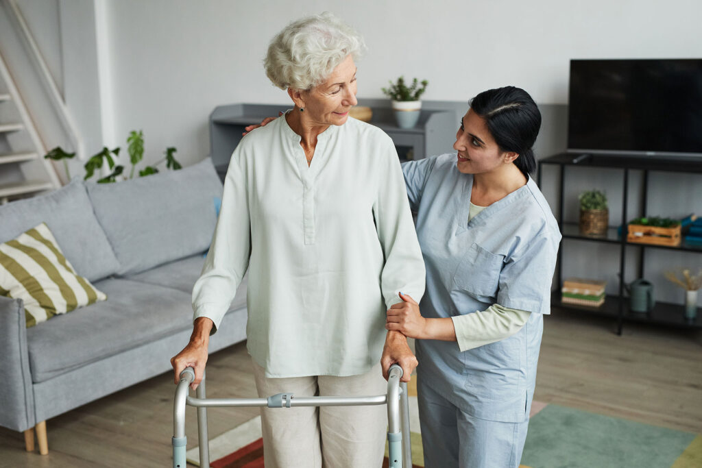 caregiver helping senior woman with walker after finding out answers to the question how does one qualify for respite care