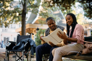 Senior man and daughter visiting each other in an outdoor area at a senior memory care community in austin tx