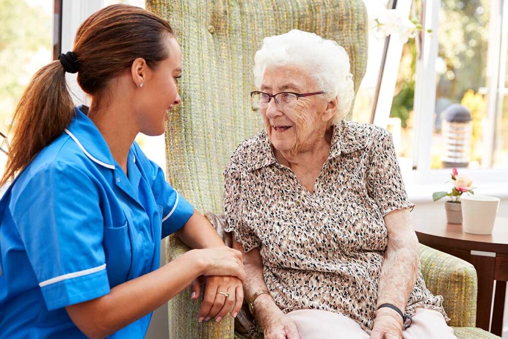 happy woman and caregiver discussing how long senior living is