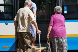 senior couple boarding a shuttle after learning the importance of transportation in senior living
