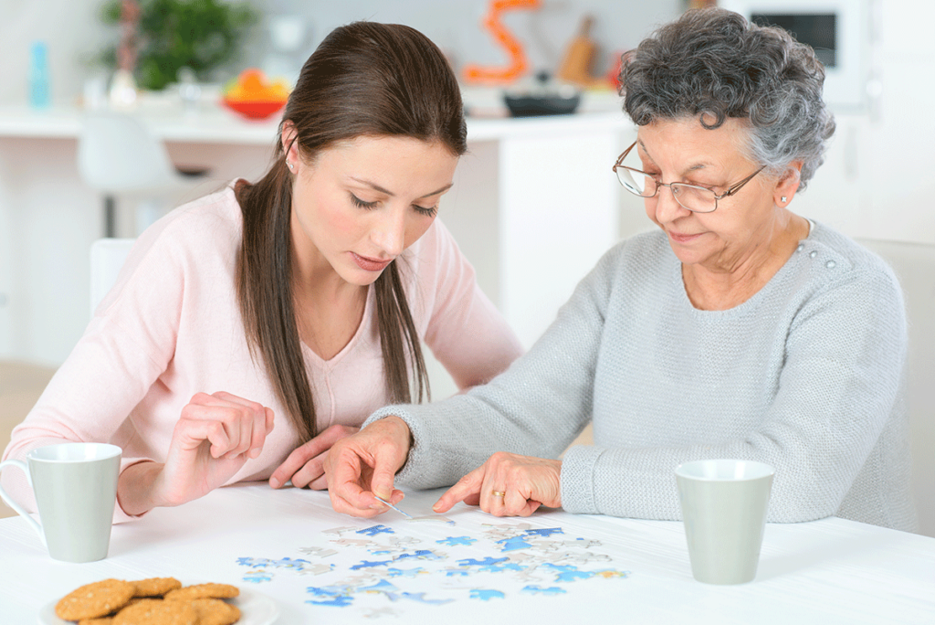 Senior and caregiver talk about finding a senior memory care center