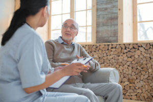 caretaker and senior man discussing the importance of mental health awareness in senior living