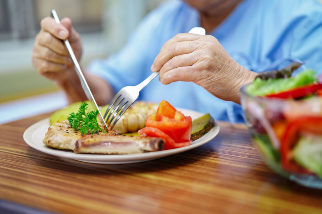 senior eating a balanced meal and overcoming the challenges of eating well in senior living