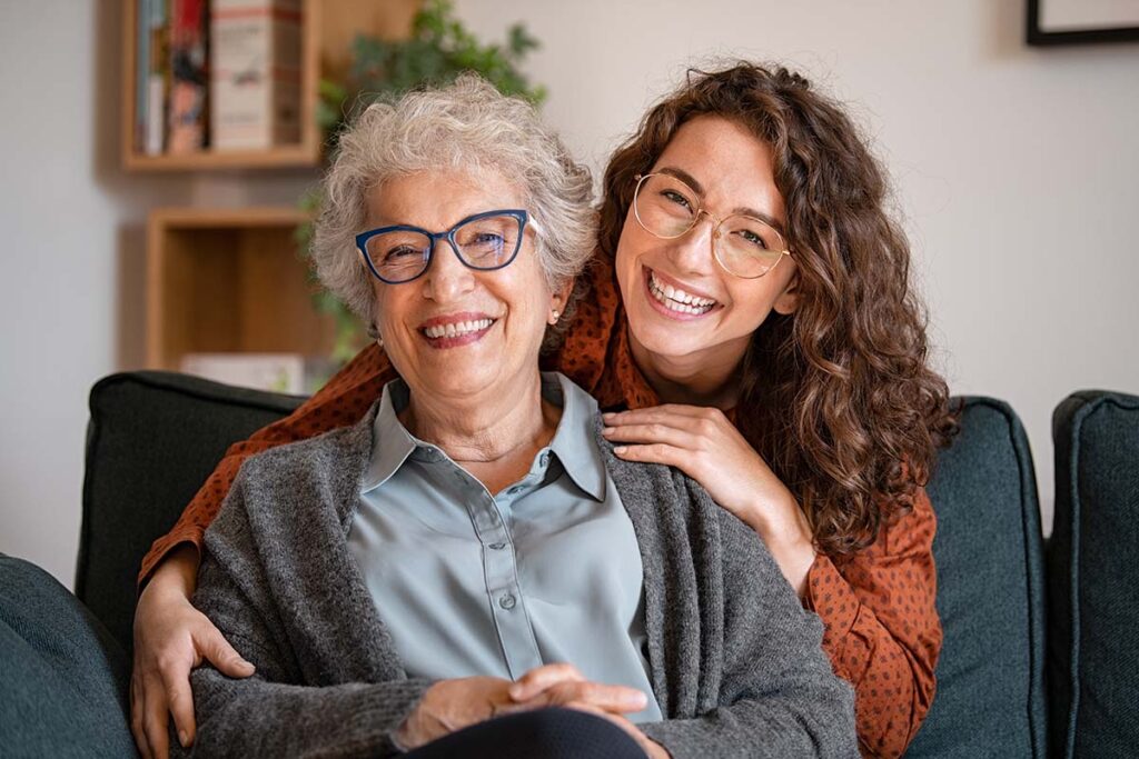 granddaughter visiting grandmother while making an effort to stay connected with loved ones in memory care