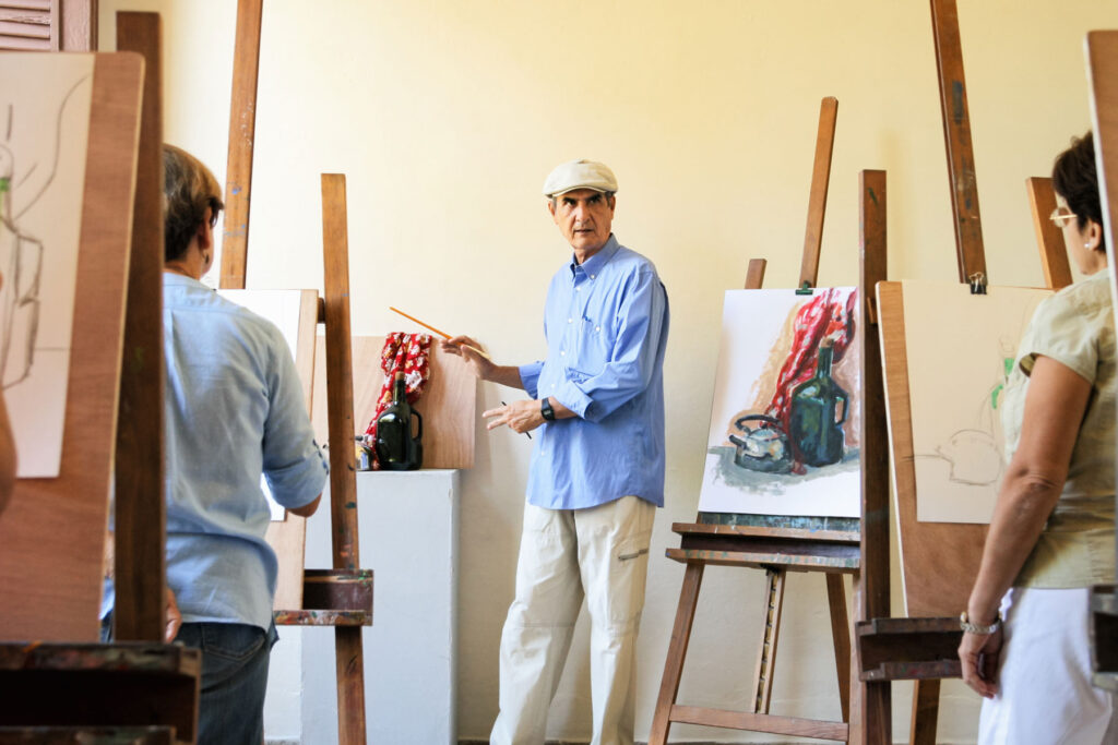 seniors taking a painting class as part of a senior living and adult education program