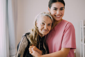 caregiver and senior smiling together in respite care for senior special needs