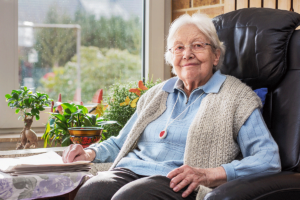 person sitting on comfortable chair and smiling while enjoying healthy aging in austin