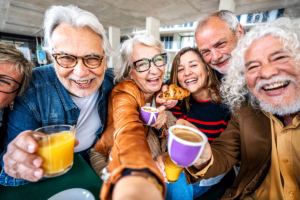 seniors smiling while having drinks and staying social in retirement